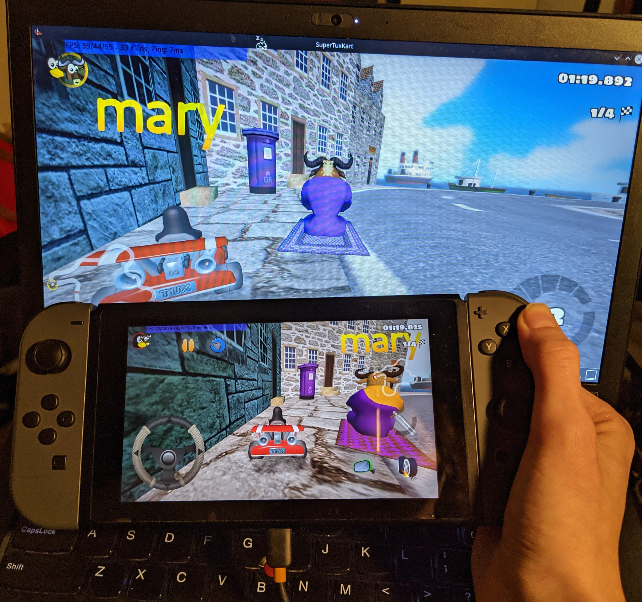 SuperTuxKart being played in a multiplayer game on a Nintendo Switch and a laptop